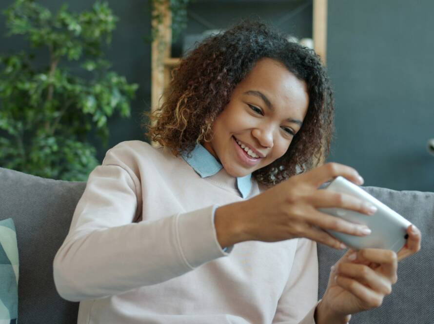 Persona che usa lo smartphone sul divano
